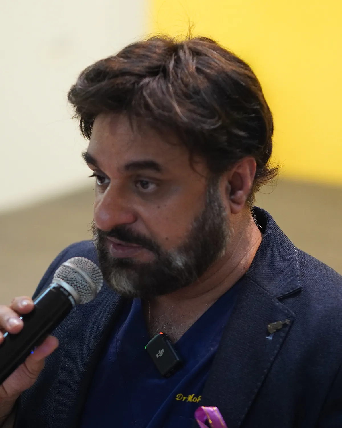 Dr Mohammad Muneeb Khan, consultant clinical oncologist and founder of Killing Cancer Kindly, speaking at a school event.
