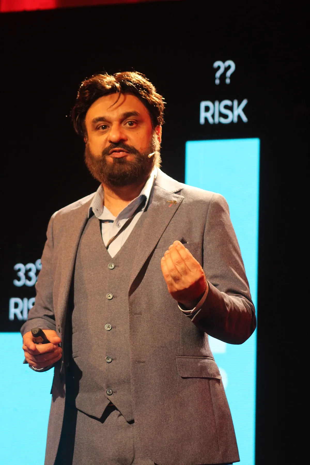 Dr Mohammad Muneeb Khan gesturing to a slide showing a reduced cancer-risk figure.