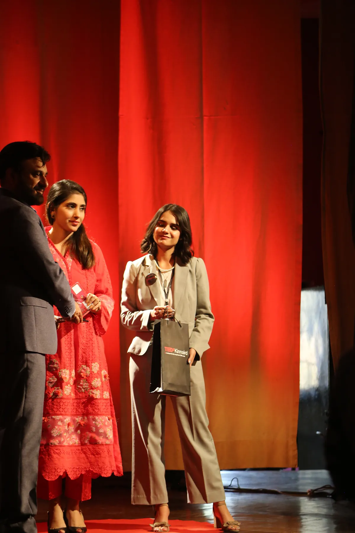 Dr Mohammad Muneeb Khan shaking hands with the event organisers at the end of his TEDx talk.